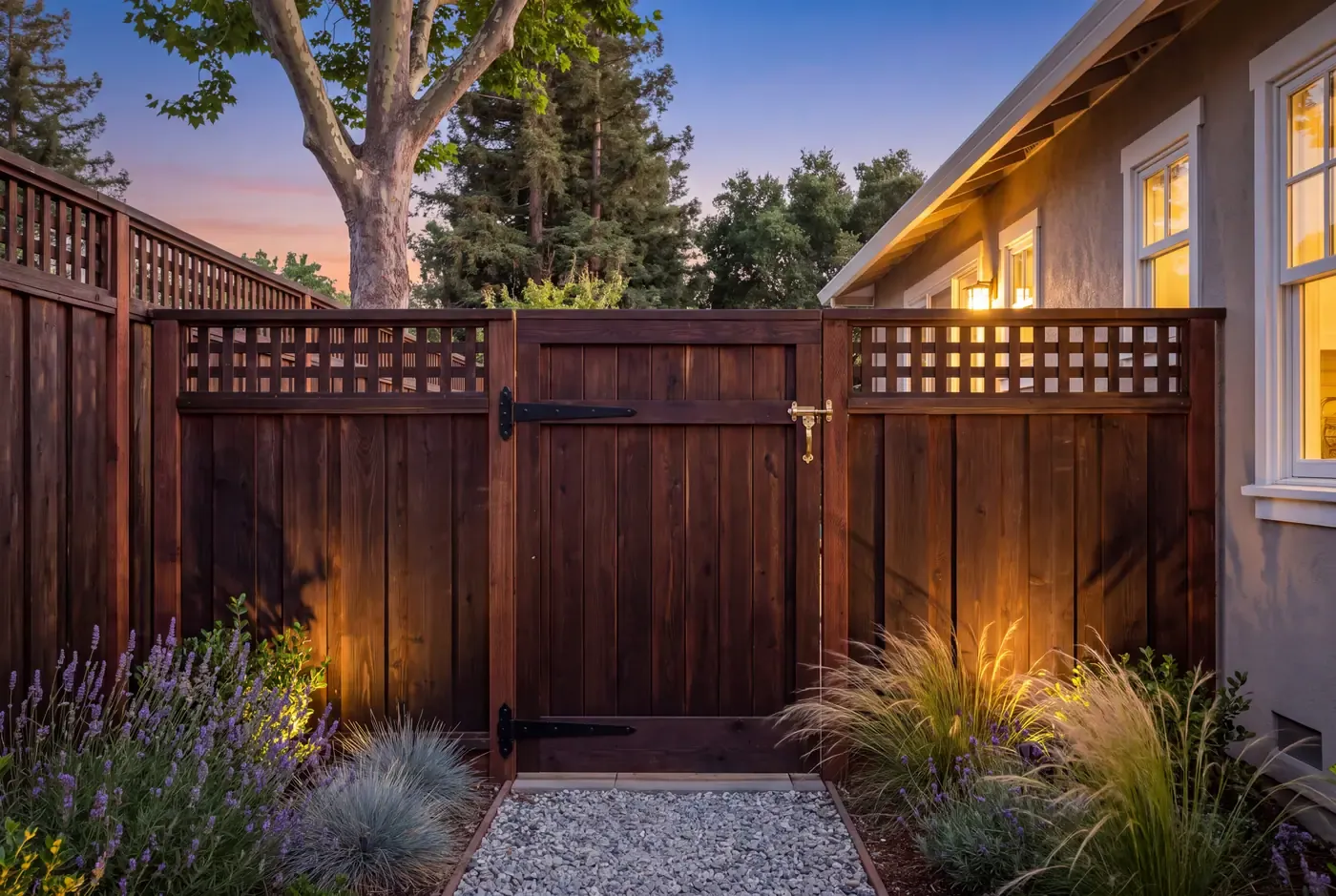 Self-closing redwood pool gate with a top-mounted brass latch and blackened steel hinges