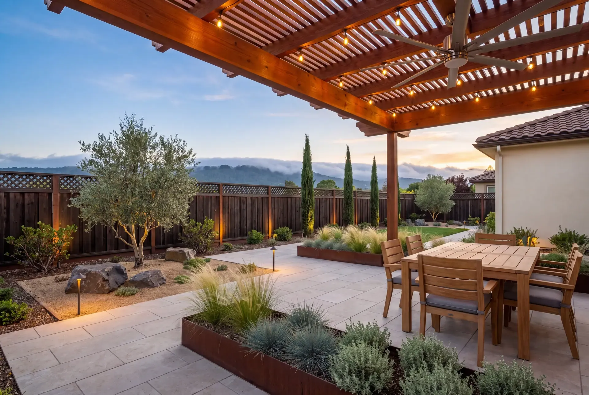 A Peninsula backyard with a slatted pergola patio in the foreground and fog rolling over the distant hills