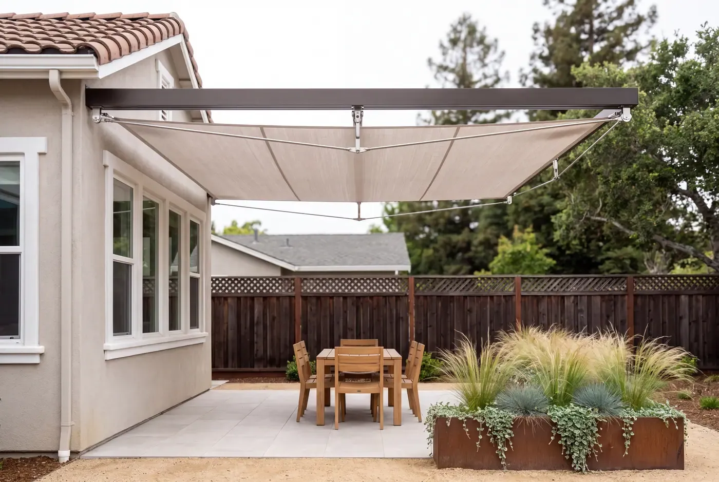 Close-up of retractable fabric canopy extended over a patio, showing the fabric texture and mounting hardware